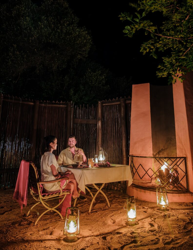couple men and woman romantic dinner on a luxury safari, South Africa