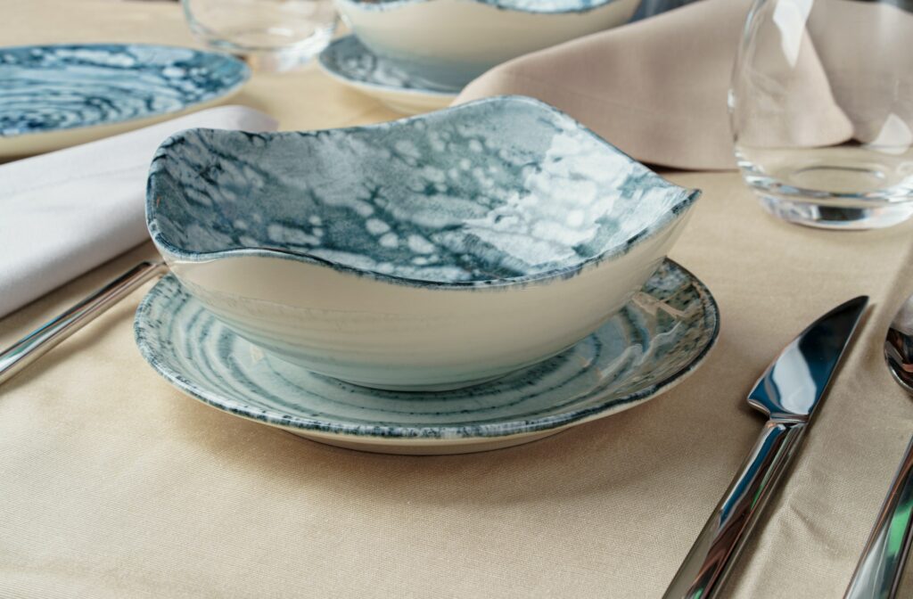 Details of a stylish table setting with textured ceramic dishes