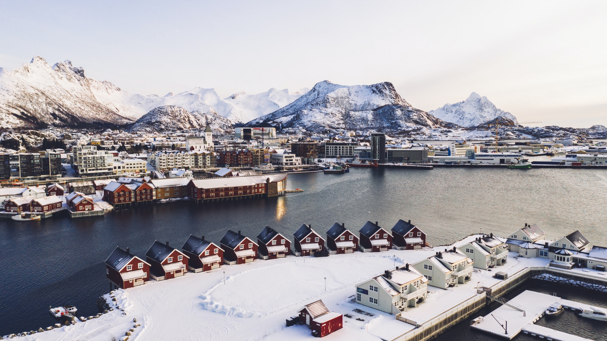 Aerial view from drone of fjord seashore with small infrastructure with real estate for vacation ren